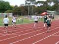 Competitors race down the track during the first official race on the new track